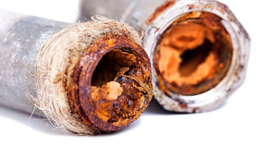 Rusty pipe ends showing severe corrosion, illustrating plumbing issues related to frozen pipes and potential health risks for homeowners.